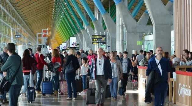 A crowded airport with travellers