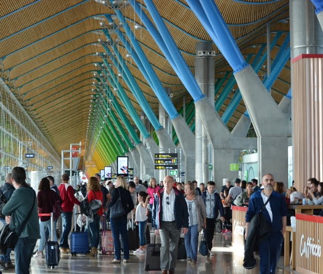A crowded airport with travellers
