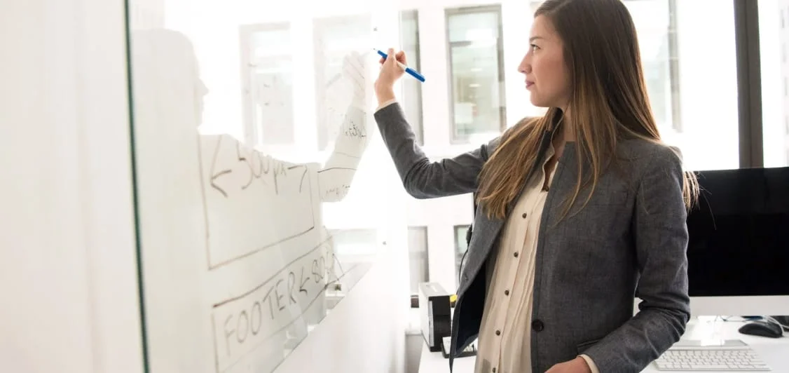 Australian Pacific College educator writing on a whiteboard